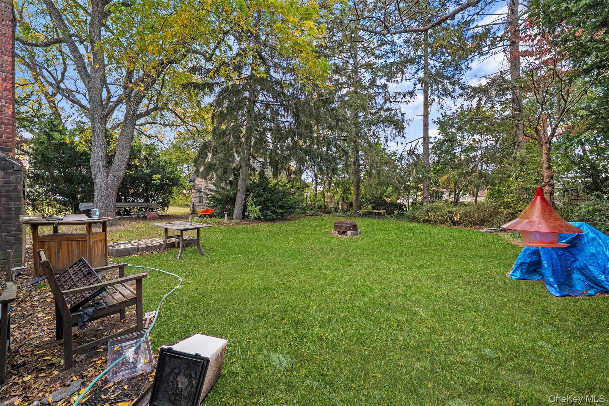 9 Tudor Road Farmingdale, NY 11735 - Photo 3 of 12 a view of backyard with table and chairs