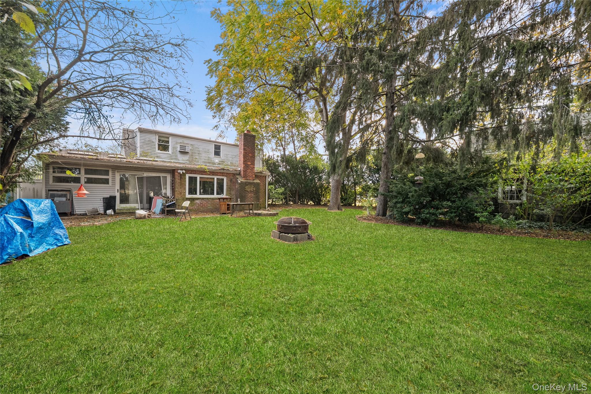 9 Tudor Road Farmingdale, NY 11735 - Photo 4 of 12 a view of a house with a big yard and large trees