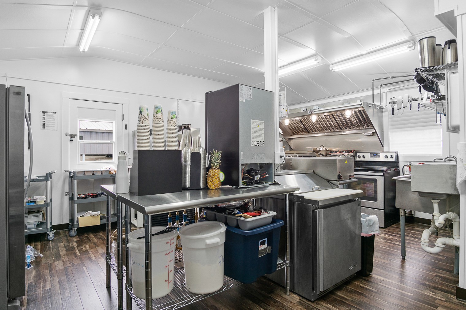 1136 Highway 87 Crystal Beach, TX 77650 - Photo 15 of 33 a kitchen with stainless steel appliances a stove top oven and a refrigerator
