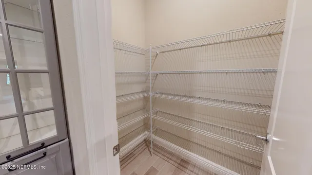 a view of a chandelier in big room and chandelier