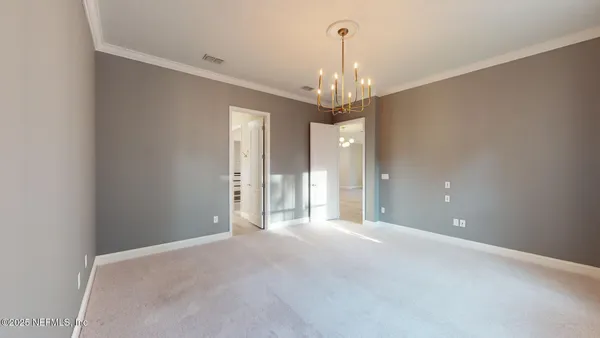 a view of a chandelier in big room and chandelier
