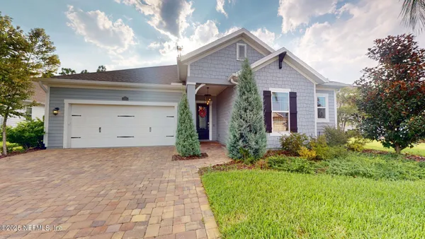 a front view of a house with garden