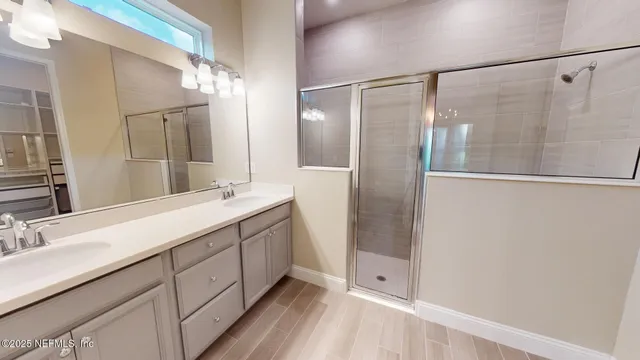 a living room with couches a fireplace and a potted plant