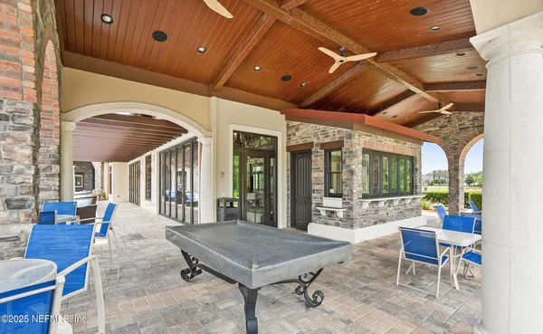 a swimming pool with outdoor seating yard and barbeque oven