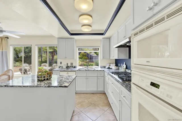 a kitchen with granite countertop a sink and a window