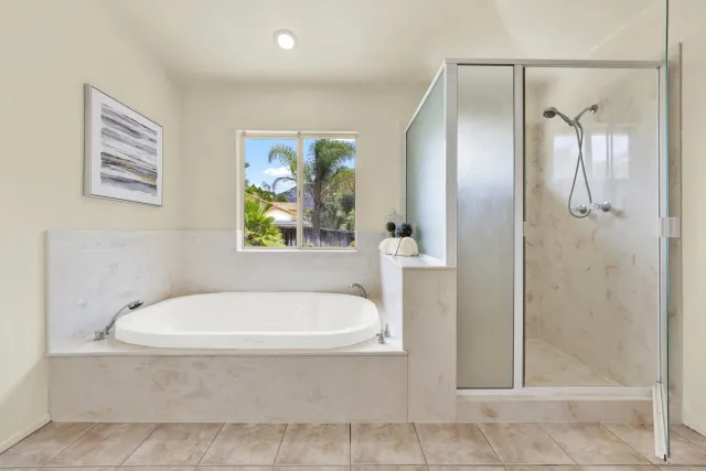 a spacious bedroom with a bed and a chandelier