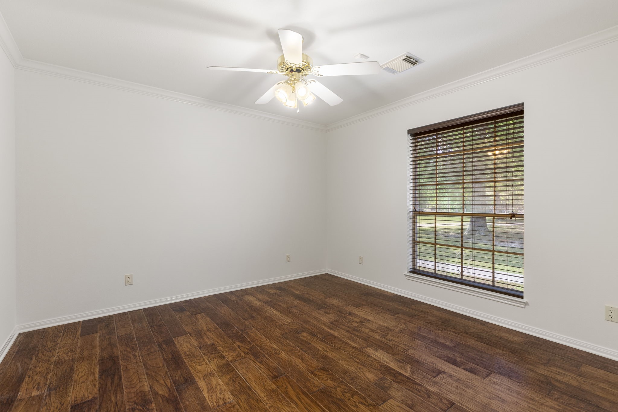 11534 Clint Parker Road Conroe, TX 77303 - Photo 14 of 50 wooden floor in an empty room with a window