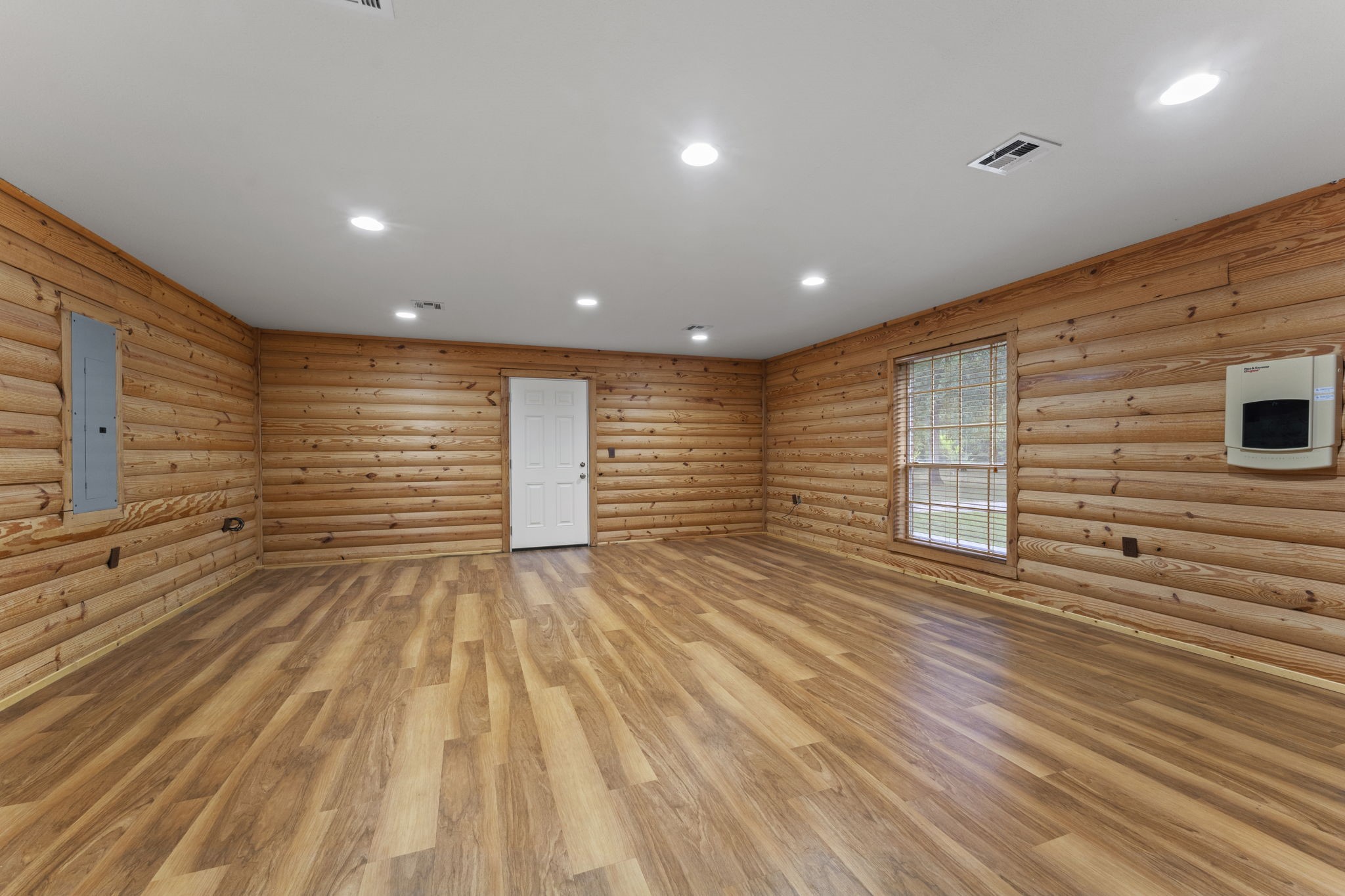 11534 Clint Parker Road Conroe, TX 77303 - Photo 15 of 50 a view of an empty room with wooden floor