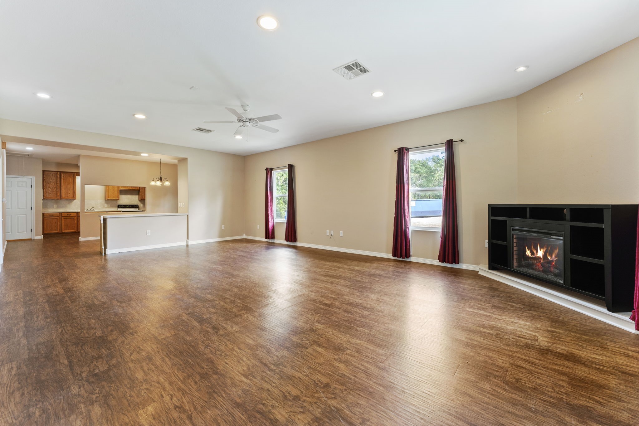 11534 Clint Parker Road Conroe, TX 77303 - Photo 32 of 50 a view of an empty room with a fireplace and a window