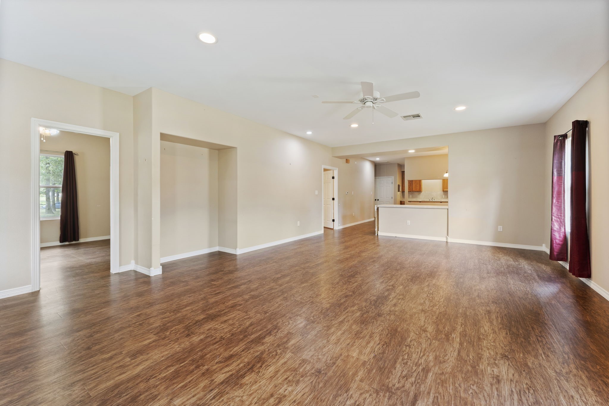 11534 Clint Parker Road Conroe, TX 77303 - Photo 33 of 50 an empty room with wooden floor and natural light