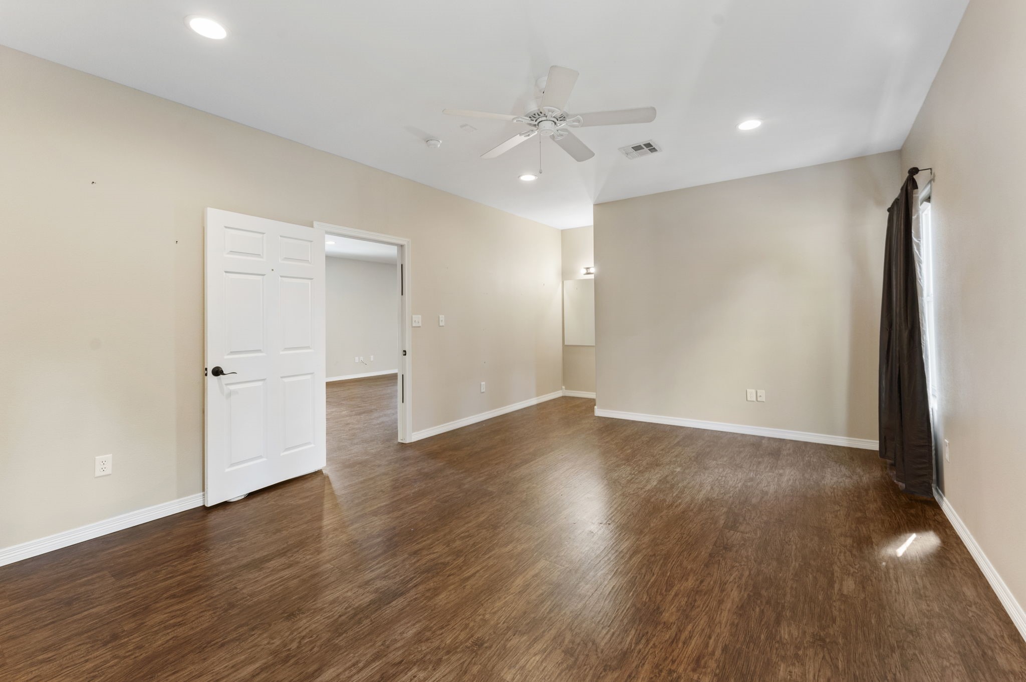 11534 Clint Parker Road Conroe, TX 77303 - Photo 38 of 50 a view of an empty room with wooden floor and a window