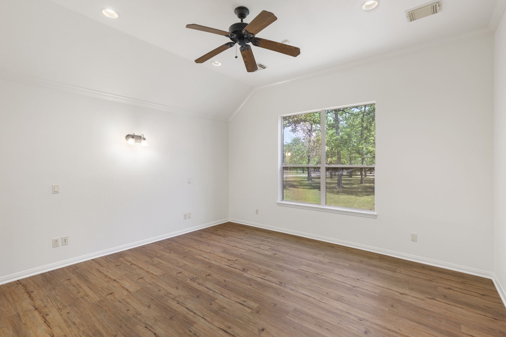 11534 Clint Parker Road Conroe, TX 77303 - Photo 6 of 50 an empty room with a window and a fan