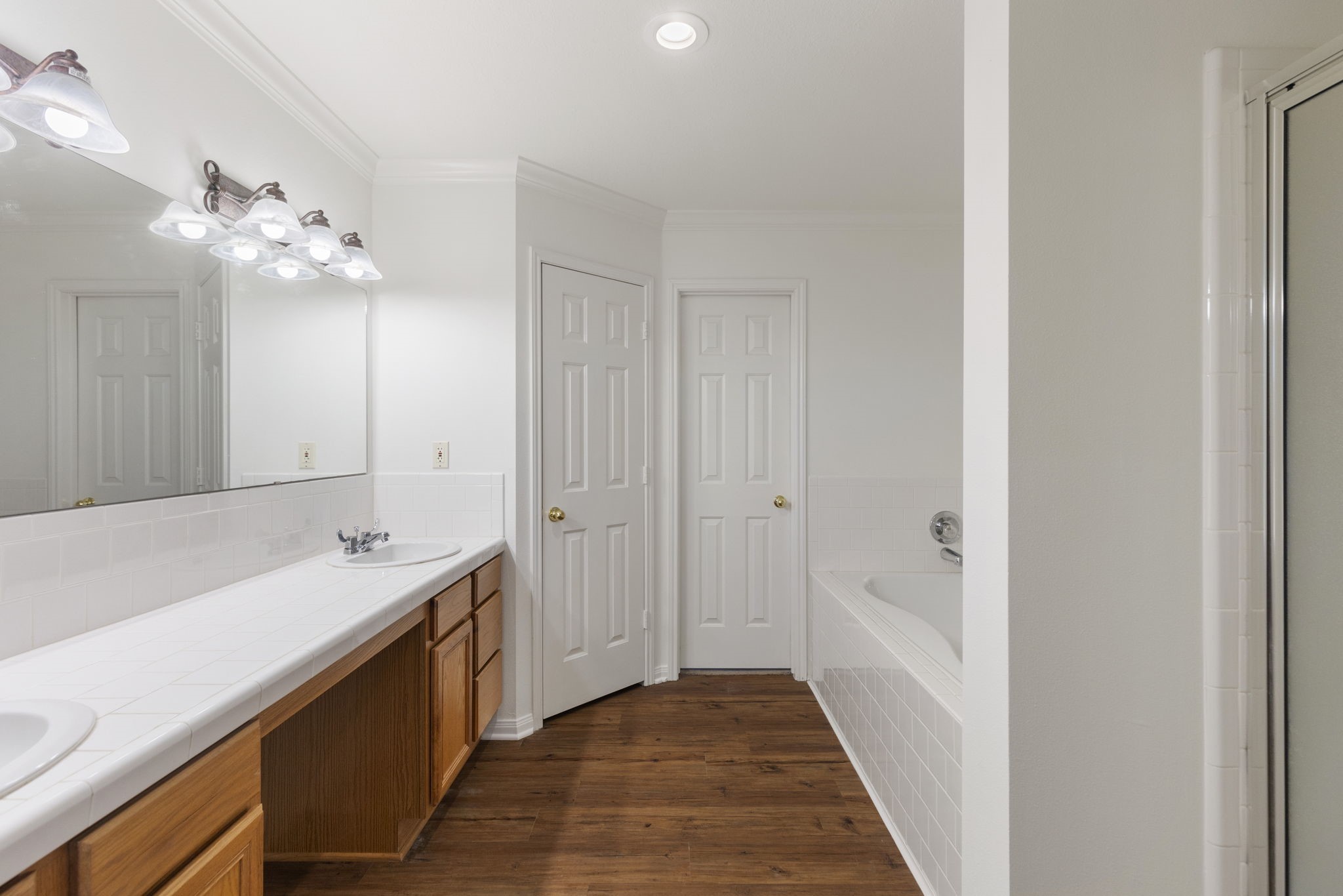 11534 Clint Parker Road Conroe, TX 77303 - Photo 7 of 50 a bathroom with a sink a mirror and a bathtub