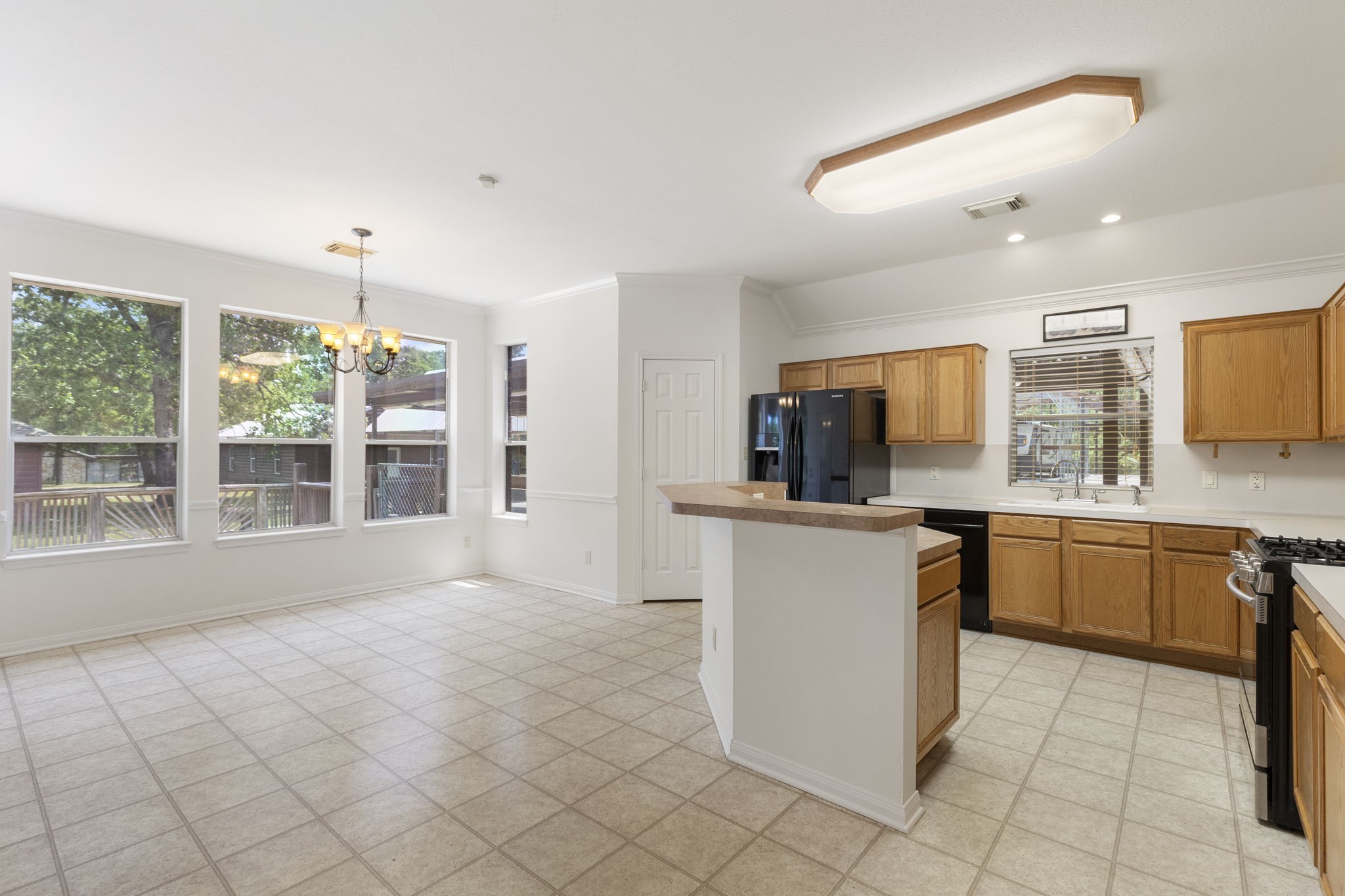 11534 Clint Parker Road Conroe, TX 77303 - Photo 10 of 50 a kitchen with sink cabinets and window