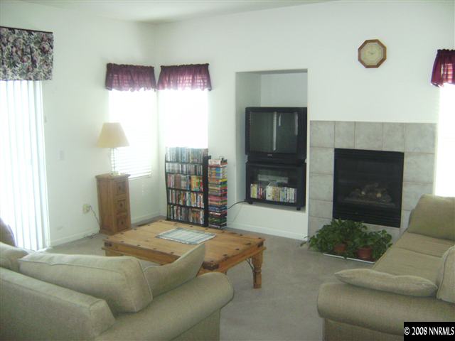 1665 Legacy Village Road Reno, NV 89521 - Photo 3 of 9 a bedroom with a bed and a fireplace