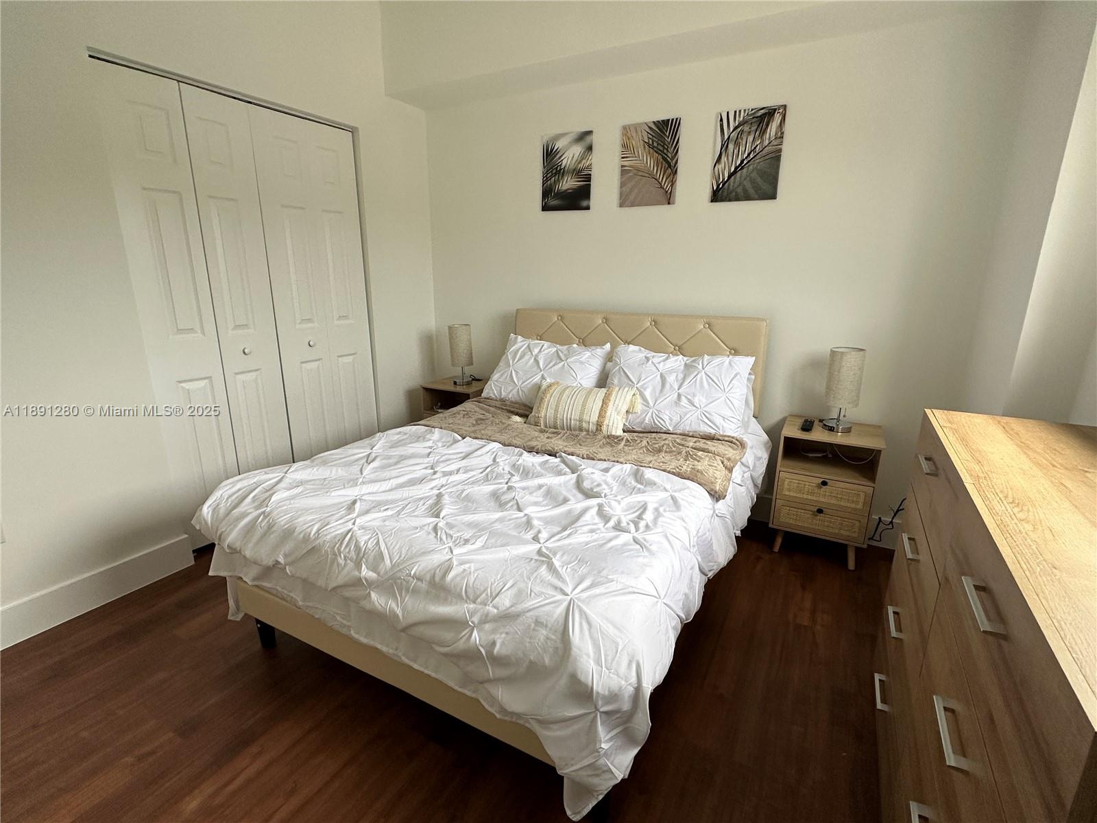 1638 Southwest 3rd Street, Unit 303 Miami, FL 33135 - Photo 11 of 17 a bed sitting in a bedroom next to a cabinet