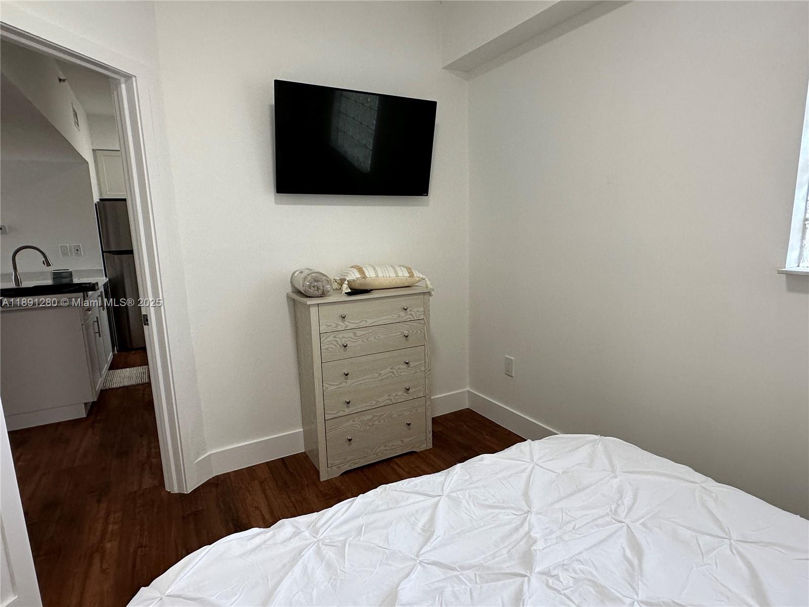 1638 Southwest 3rd Street, Unit 303 Miami, FL 33135 - Photo 14 of 17 a bedroom with a bed and a flat screen tv