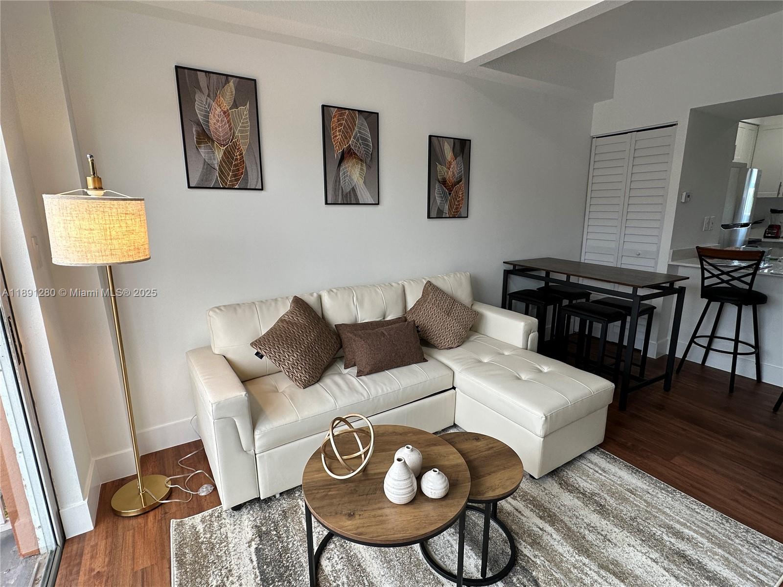 1638 Southwest 3rd Street, Unit 303 Miami, FL 33135 - Photo 5 of 17 a living room with furniture and wooden floor
