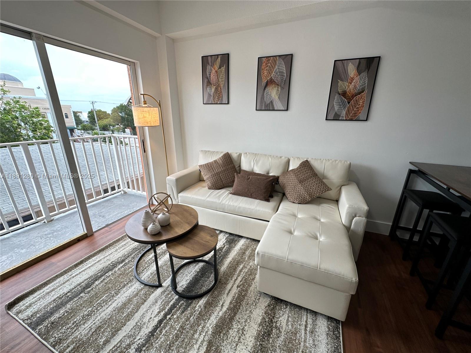 1638 Southwest 3rd Street, Unit 303 Miami, FL 33135 - Photo 6 of 17 a living room with furniture and a window