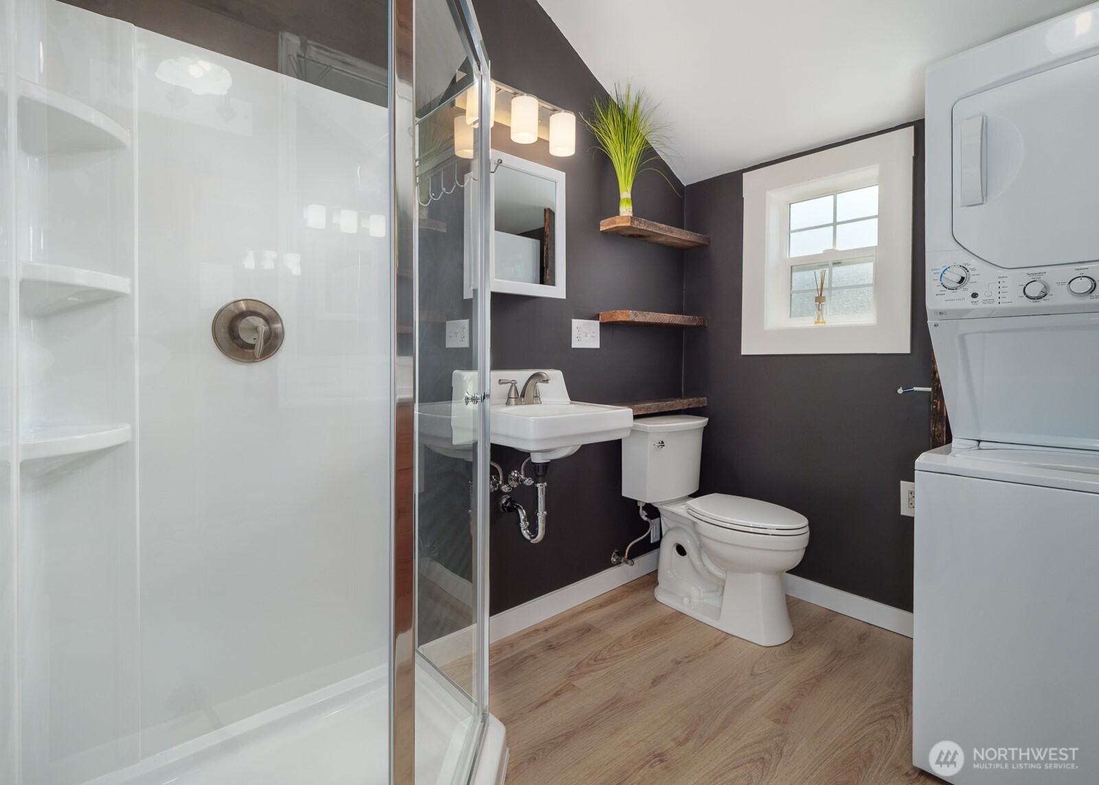 233 West Washington Street Sequim, WA 98382 - Photo 8 of 40 a bathroom with a toilet sink and shower