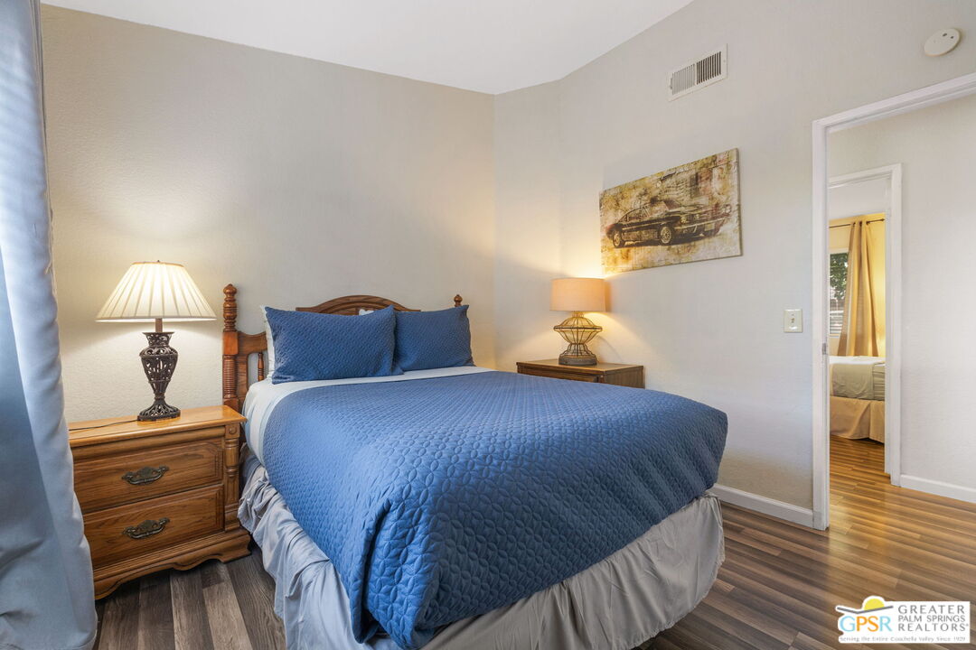 45688 Sutter Creek Road Indio, CA 92201 - Photo 31 of 51 a bedroom with a bed and wooden floor