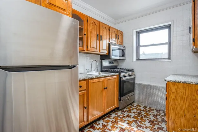 a kitchen with stainless steel appliances granite countertop a refrigerator and a sink