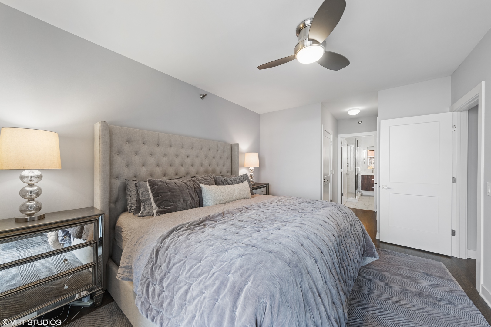 55 West Delaware Place, Unit 613 Chicago, IL 60610 - Photo 11 of 29 a bedroom with a bed and a lamp