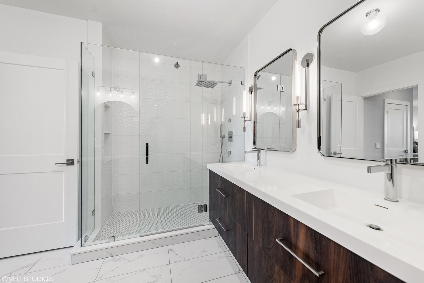 55 West Delaware Place, Unit 613 Chicago, IL 60610 - Photo 14 of 29 a bathroom with a double vanity sink shower and mirror
