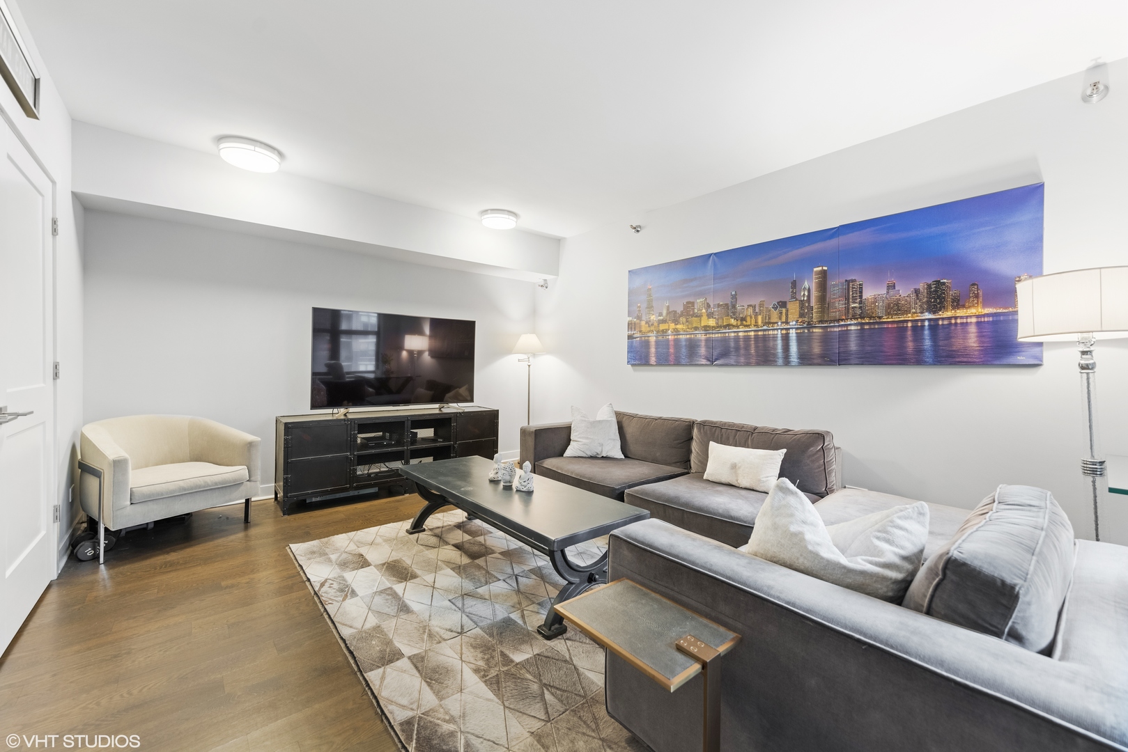 55 West Delaware Place, Unit 613 Chicago, IL 60610 - Photo 19 of 29 a living room with furniture and a flat screen tv