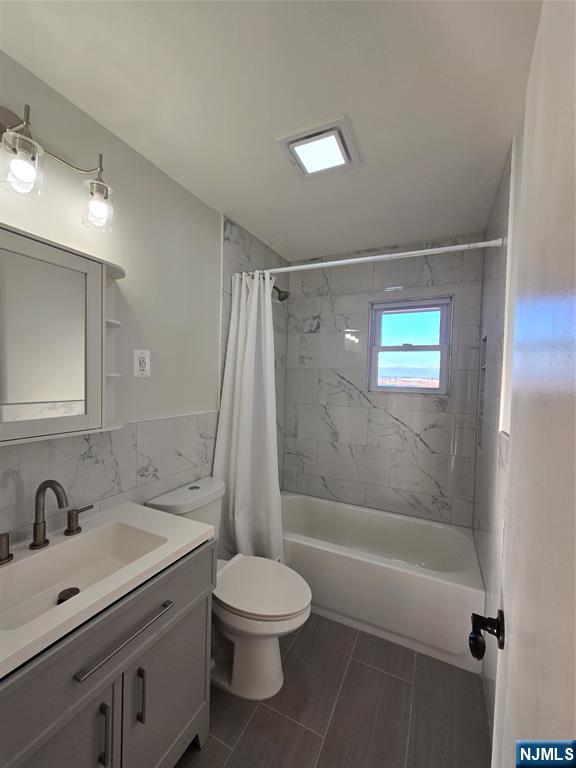 691 9th Street, Unit 2 Secaucus, NJ 07094 - Photo 13 of 16 a bathroom with a sink mirror vanity and toilet