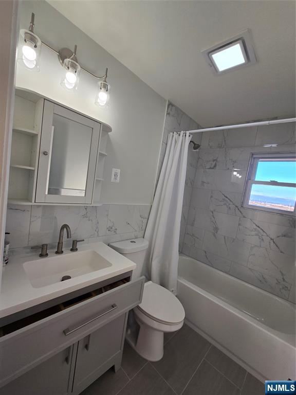 691 9th Street, Unit 2 Secaucus, NJ 07094 - Photo 14 of 16 a bathroom with a sink a toilet and shower