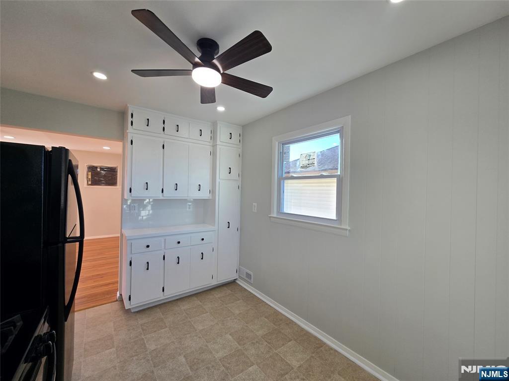 691 9th Street, Unit 2 Secaucus, NJ 07094 - Photo 8 of 16 a view of an empty room with cabinet and a window