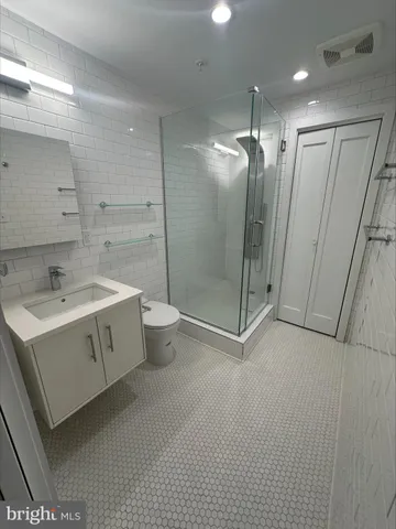 a bathroom with a double vanity sink toilet and shower