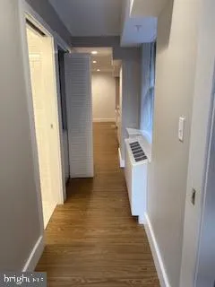 a view of a hallway with wooden floor and staircase