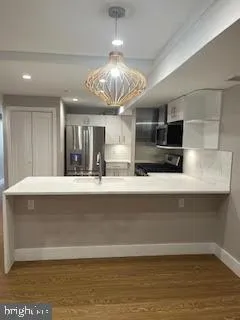 a large kitchen with stainless steel appliances a large counter top