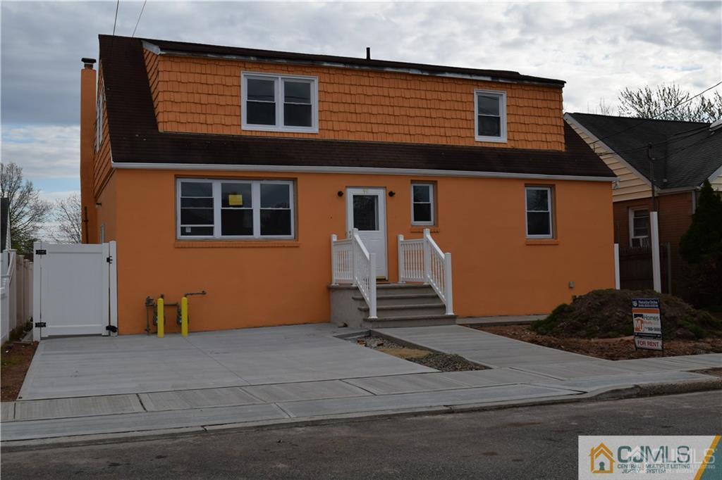90 Holly Street, Unit 2 Port Reading, NJ 07064 - Photo 2 of 8 a front view of a house with garage