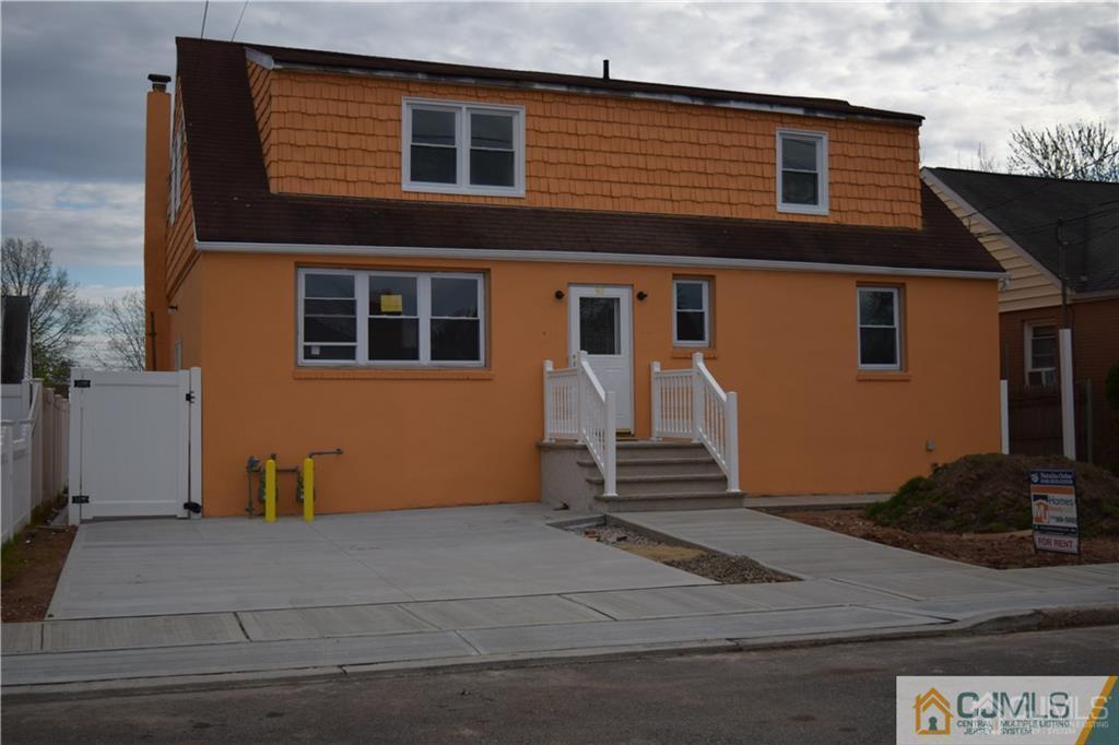 90 Holly Street, Unit 2 Port Reading, NJ 07064 - Photo 3 of 8 a front view of a house with a yard