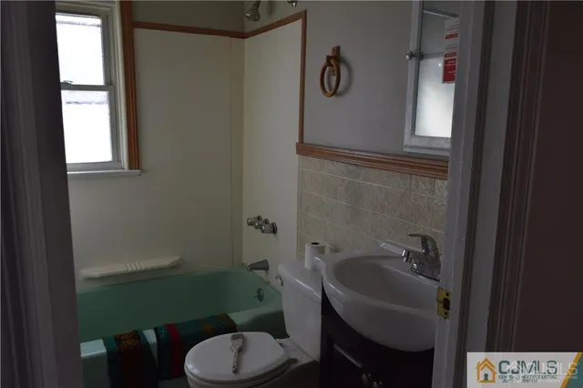 a bathroom with a sink toilet and mirror