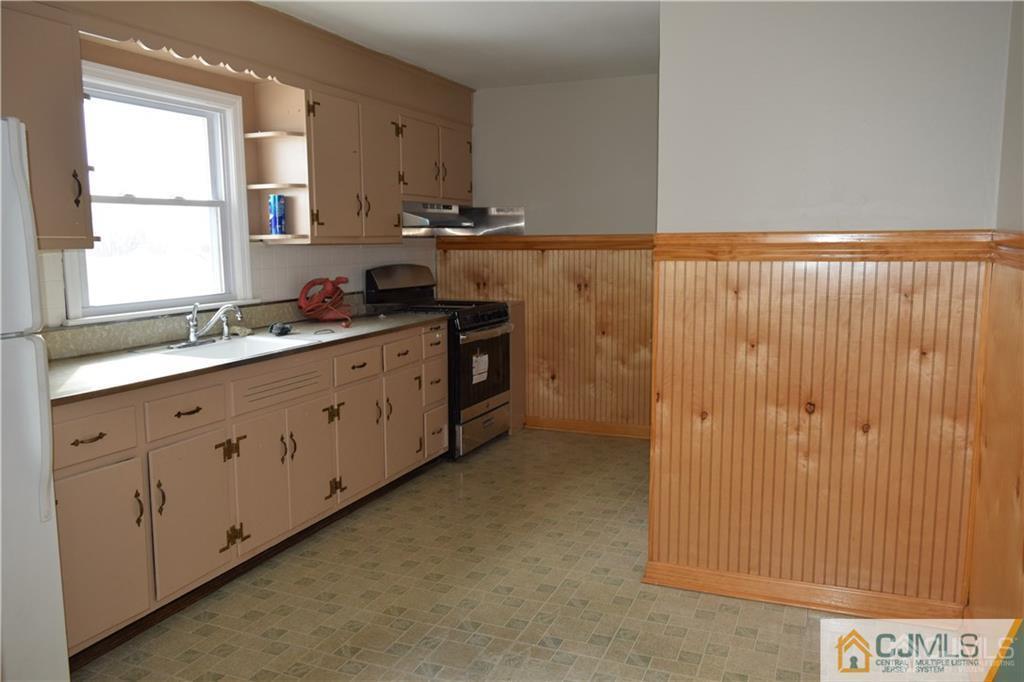 90 Holly Street, Unit 2 Port Reading, NJ 07064 - Photo 8 of 8 a kitchen with appliances cabinets and a window
