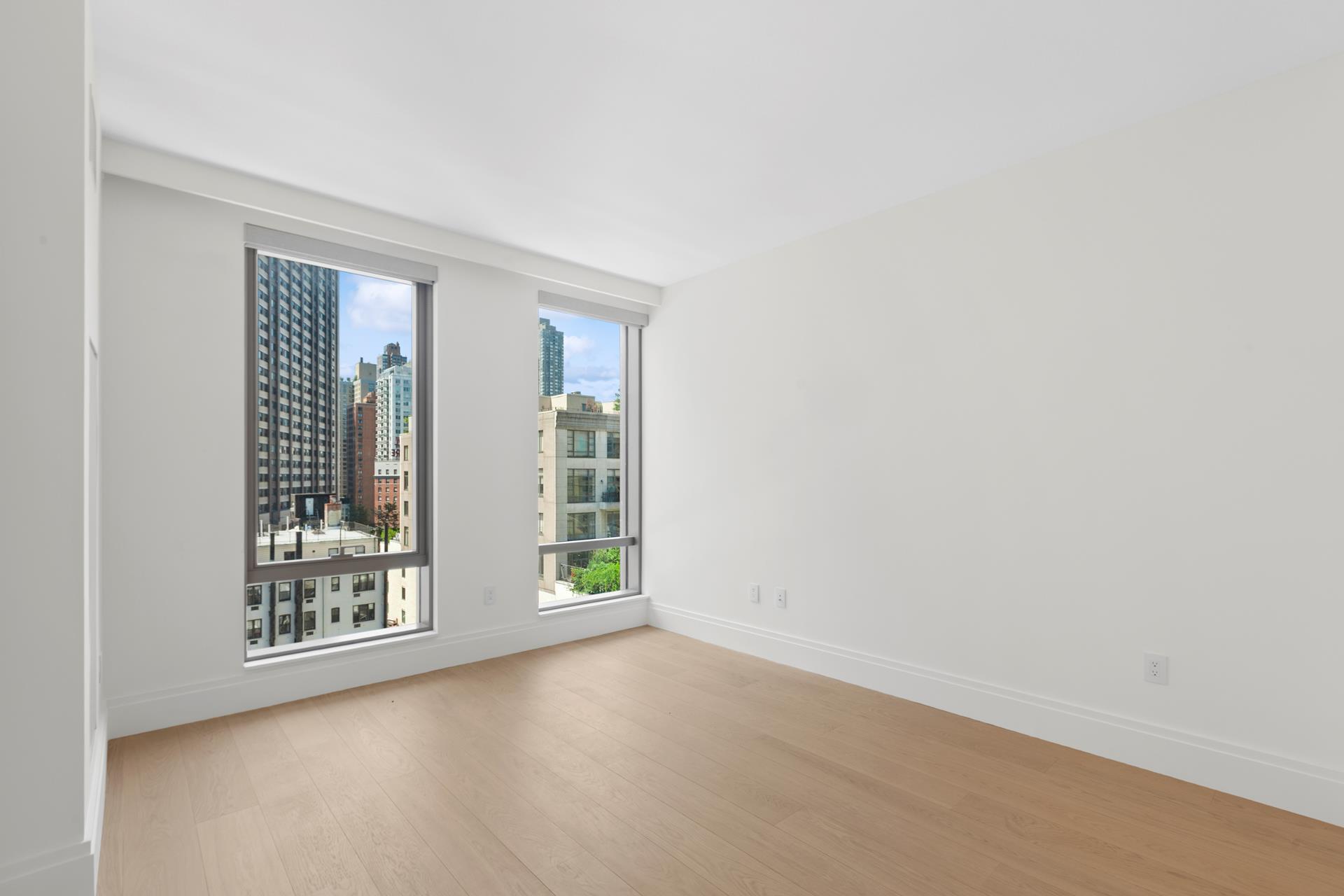 50 West 66th Street, Unit 15E Manhattan, NY 10023 - Photo 10 of 12 an empty room with windows and closet