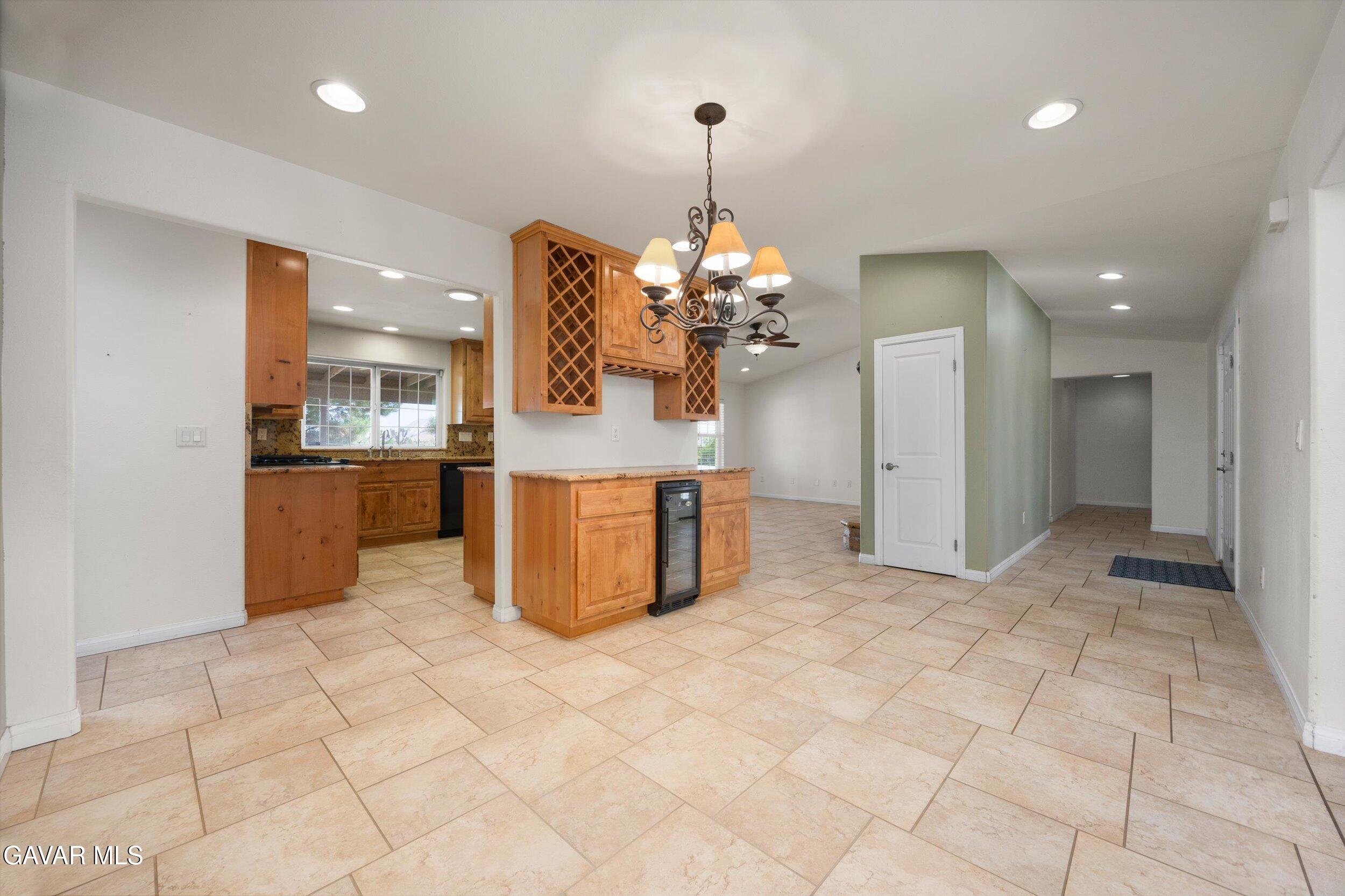4961 Montiverde Road Mojave, CA 93501 - Photo 26 of 57 a view of a kitchen with granite countertop a sink and a refrigerator