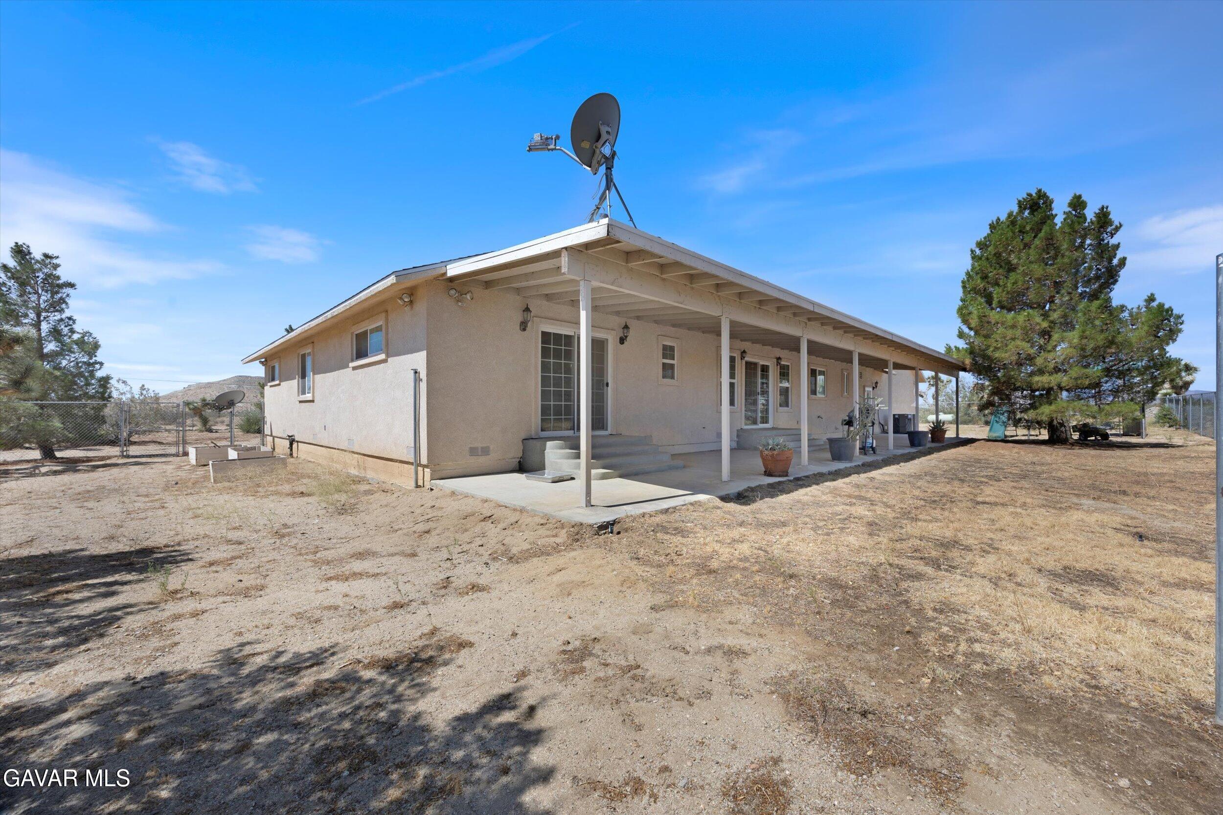 4961 Montiverde Road Mojave, CA 93501 - Photo 49 of 57 a view of a house with a yard