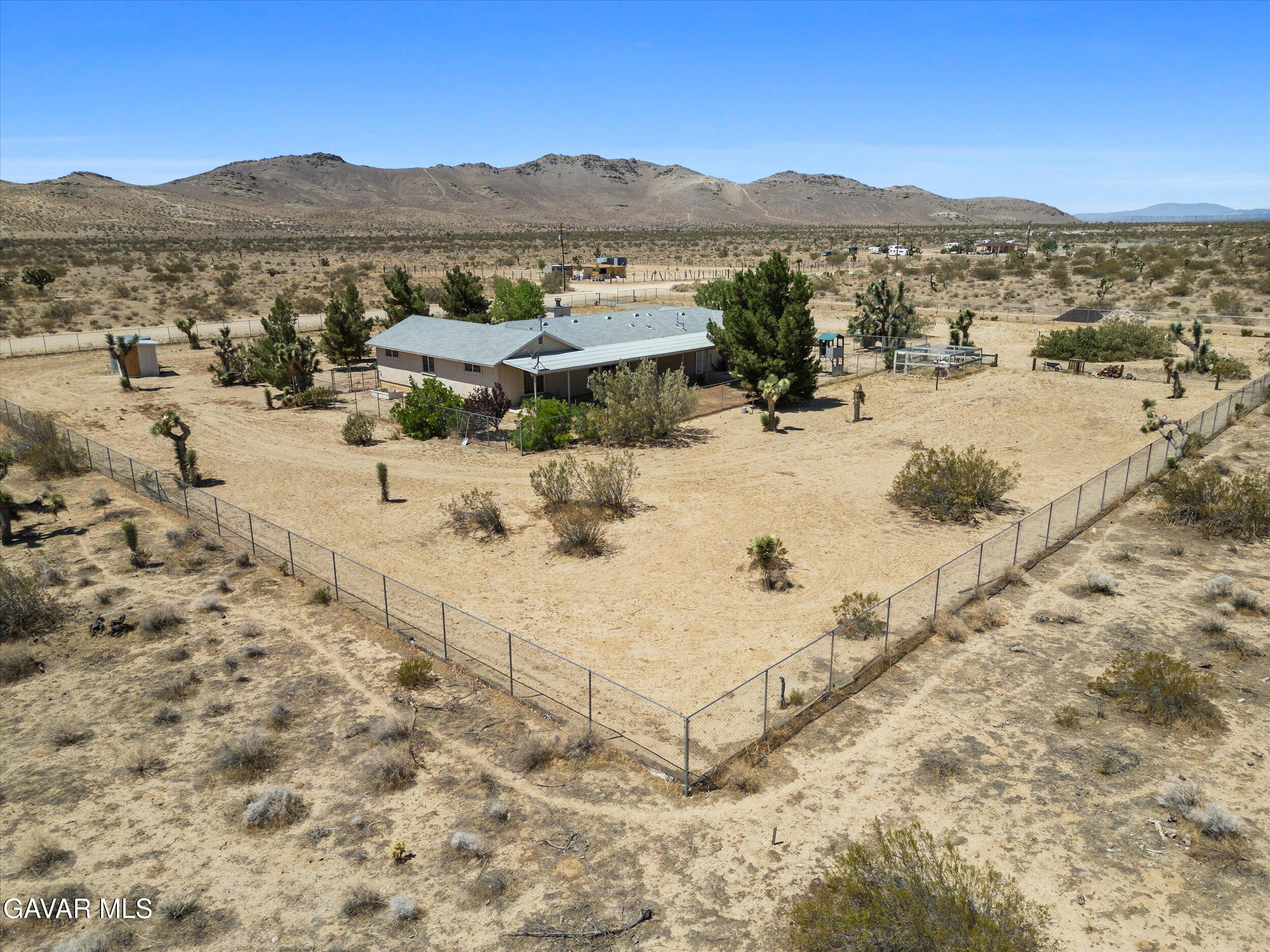 4961 Montiverde Road Mojave, CA 93501 - Photo 8 of 57 a view of a dry yard with mountains in the background