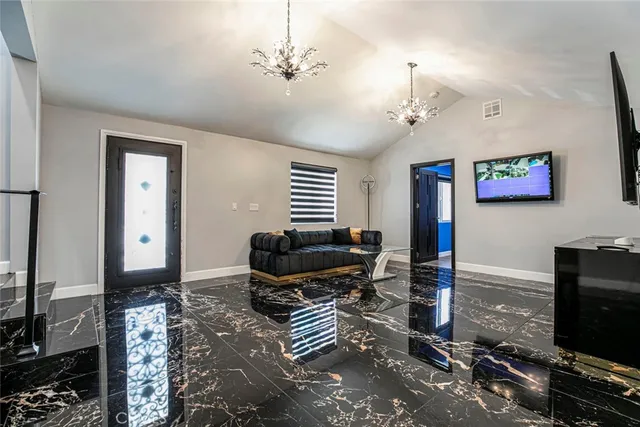 a kitchen with a stove and a flat screen tv