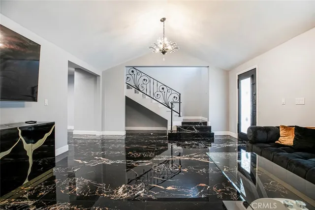 a view of a livingroom with furniture and a flat screen tv