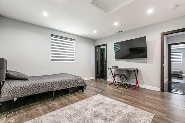 a bedroom with a bed and glass door