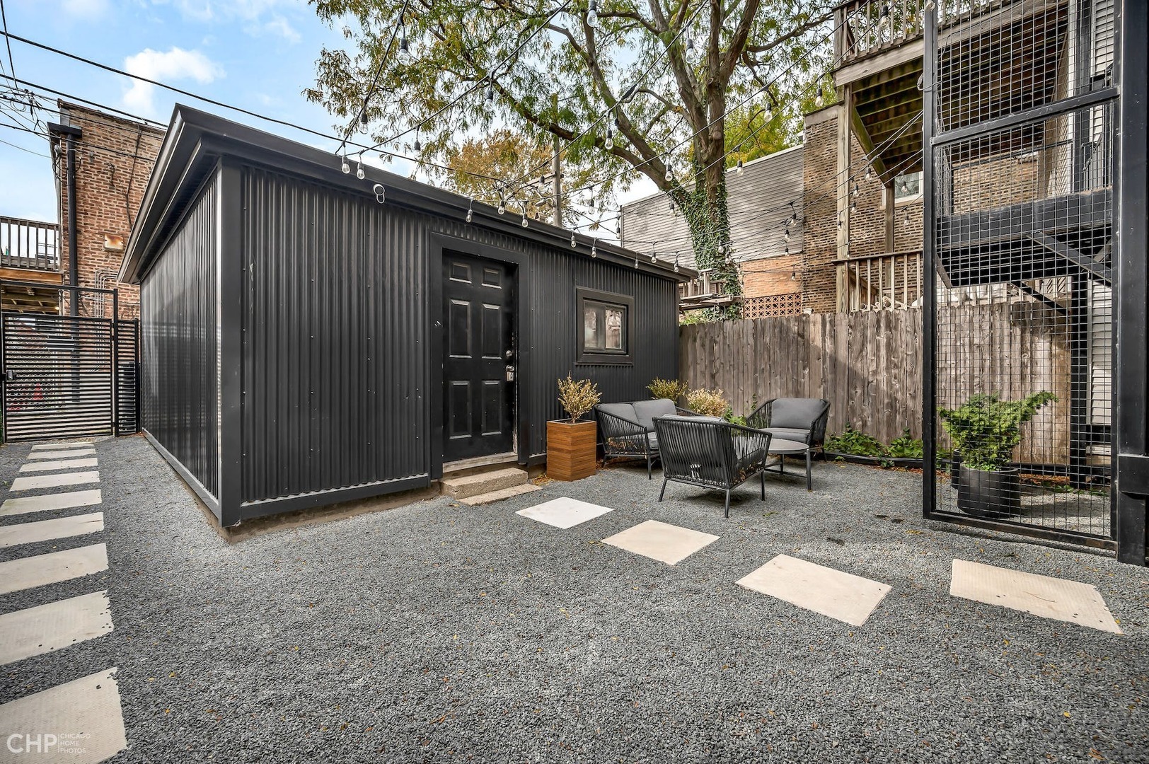 2014 North Oakley Avenue, Unit 1 Chicago, IL 60647 - Photo 18 of 19 a backyard of a house with table and chairs