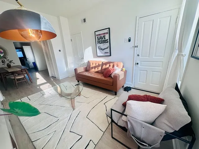 a bedroom with furniture and a rug