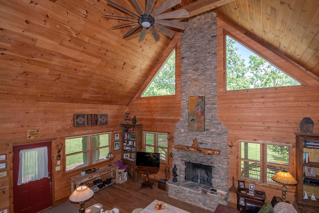 41 Pine Trail Warne, NC 28909 - Photo 12 of 43 a living room with furniture a fireplace and a floor to ceiling window