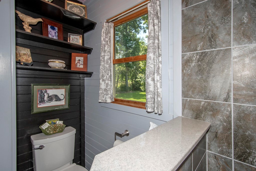 41 Pine Trail Warne, NC 28909 - Photo 28 of 43 a bathroom with a toilet a sink and a window